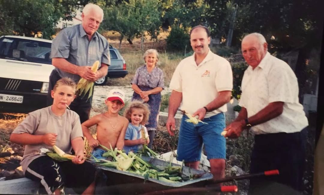 Four generations of the family shucking corn in Italy